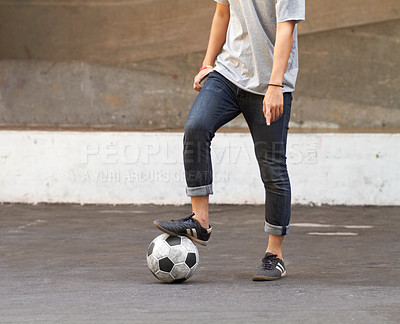 Buy stock photo Shot of a young people playing football in the street