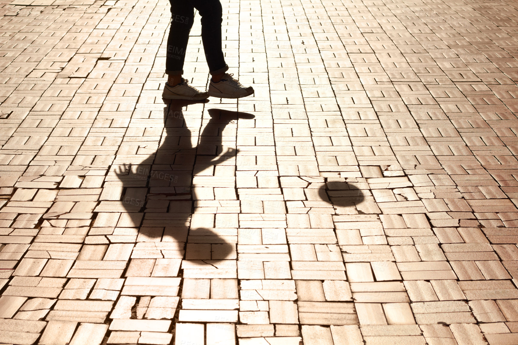 Buy stock photo Sports, soccer and man shadow with a ball training for a skill, trick or stunt on a pavement. Silhouette, football and legs of a male person practicing for a game, match or tournament in the city.