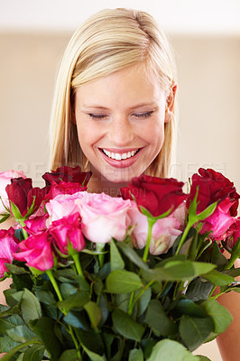 Buy stock photo Woman, rose bouquet and eyes closed with smile, floral arrangement and background with gift, happy or surprise.  Smell, female model or flowers for love, present and romantic valentines day
