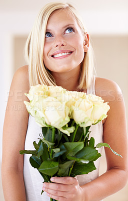 Buy stock photo A young woman holding a bunch of roses