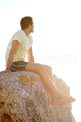 Buy stock photo Man, sitting or rock and cliff in nature for travel, adventure or scenery with sunshine, thinking and view. Person, mountain or sky for holiday, vacation or experience outdoor and freedom or barefoot