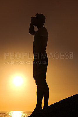 Buy stock photo Silhouette, man or looking with hands for view, scenery and wellness on beach with sunset and peace. Person, shadow or adventure and relax for holiday, vacation or experience by ocean or sea with sun