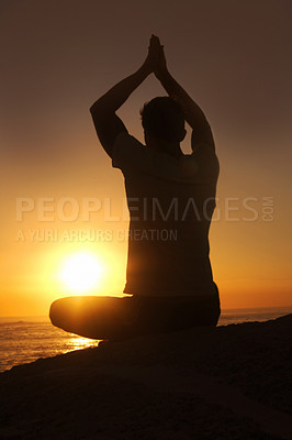 Buy stock photo Silhouette of a man against the sunset with his arms raised in a yoga pose