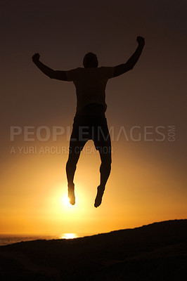 Buy stock photo Silhouette of a man jumping in the air with the sunset in the background