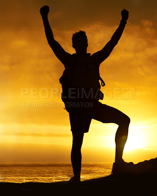 Buy stock photo Silhouette of a hiker standing on a mountain with his arms raised