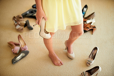 Buy stock photo Cropped image of a woman standing in her room surrounded by shoes