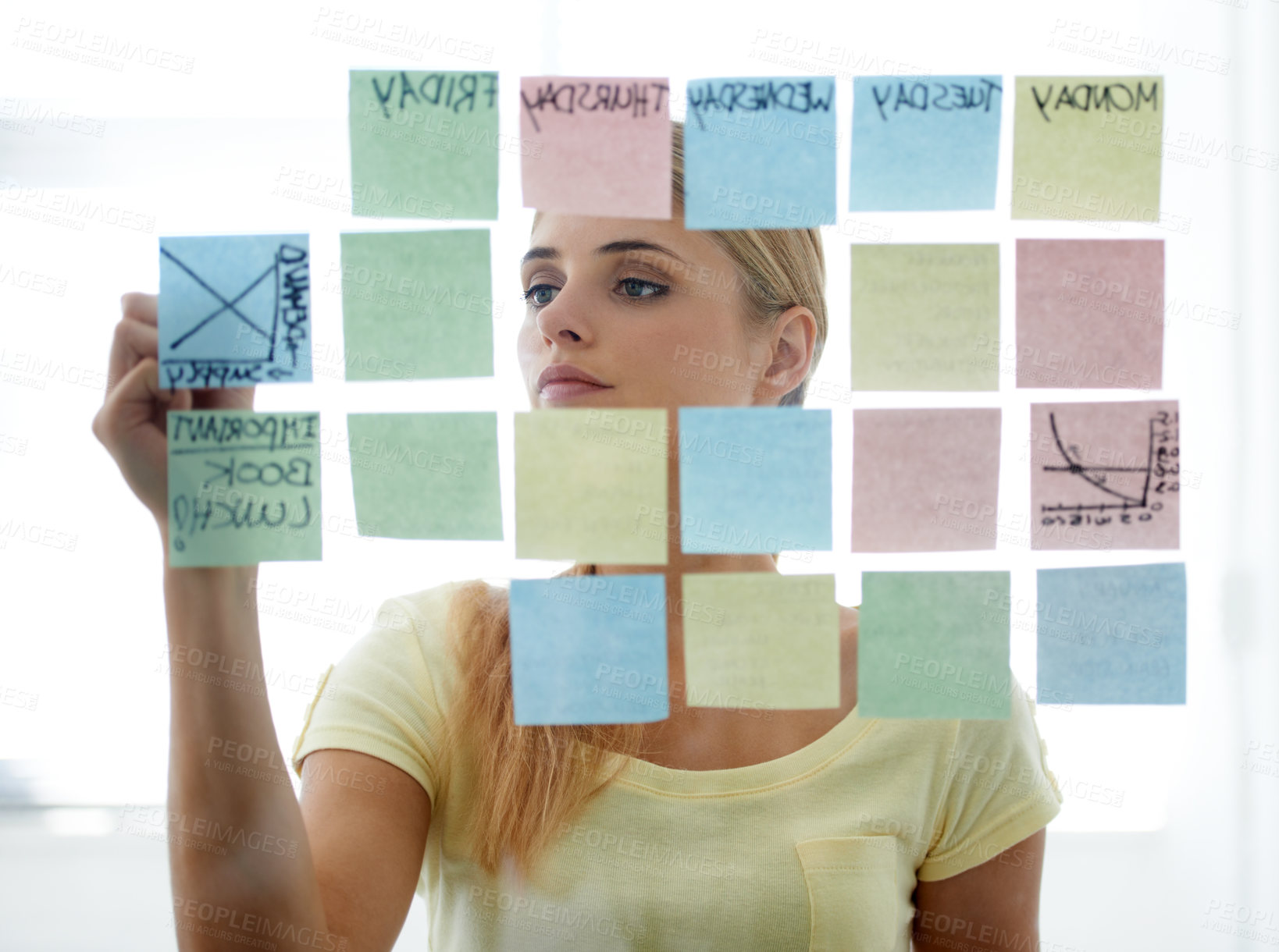 Buy stock photo Woman, writing on sticky notes and glass wall with schedule, serious and planning. Copywriter, brainstorming and office job with calendar, workplace and moodboard for ideas, content plan and creative