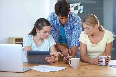 Buy stock photo Cropped shot of three colleagues working in an office