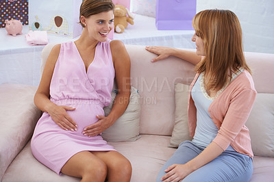 Buy stock photo Women, babyshower and hands on stomach, living room couch and happy with baby moving. Pregnant lady, smile and excited for pregnancy, motherhood and celebrating child with friends in family home