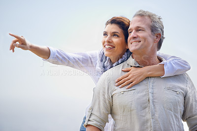 Buy stock photo Happy couple, pointing and travel together with love, happiness and cruise adventure in summer. Retirement, vacation and mature man and woman hug and sightseeing on holiday with sky mockup space