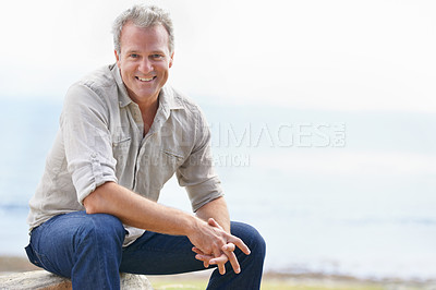 Buy stock photo Happy, mature man and portrait on holiday at beach with freedom to relax in nature with view of ocean. Smile, outdoor and person in morning on island vacation with blue sky, sea and mockup space