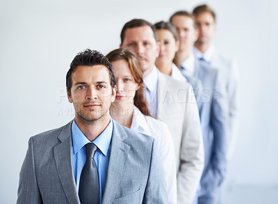 Buy stock photo Man, portrait and happy for future finance career, standing and ready for job interview. Worker, corporate accountant in suit and professional in workplace, people in background and confident
