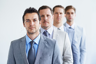 Buy stock photo Men, portrait and serious for job interview, finance career and ready for selection process. Worker, corporate accountant in suit or professional in workplace, colleagues in background and confident
