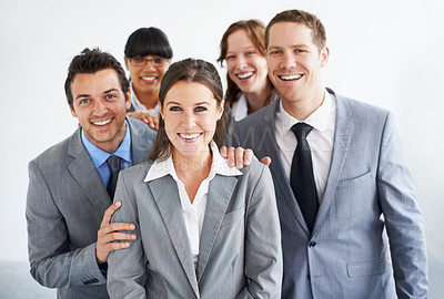 Buy stock photo A group of businesspeople standing proudly with their leader