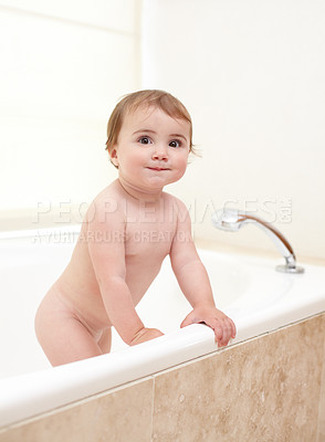 Buy stock photo An adorable baby girl climbing out of the bath