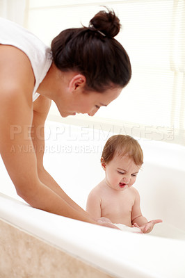 Buy stock photo A mother washing her cute baby girl in the bath