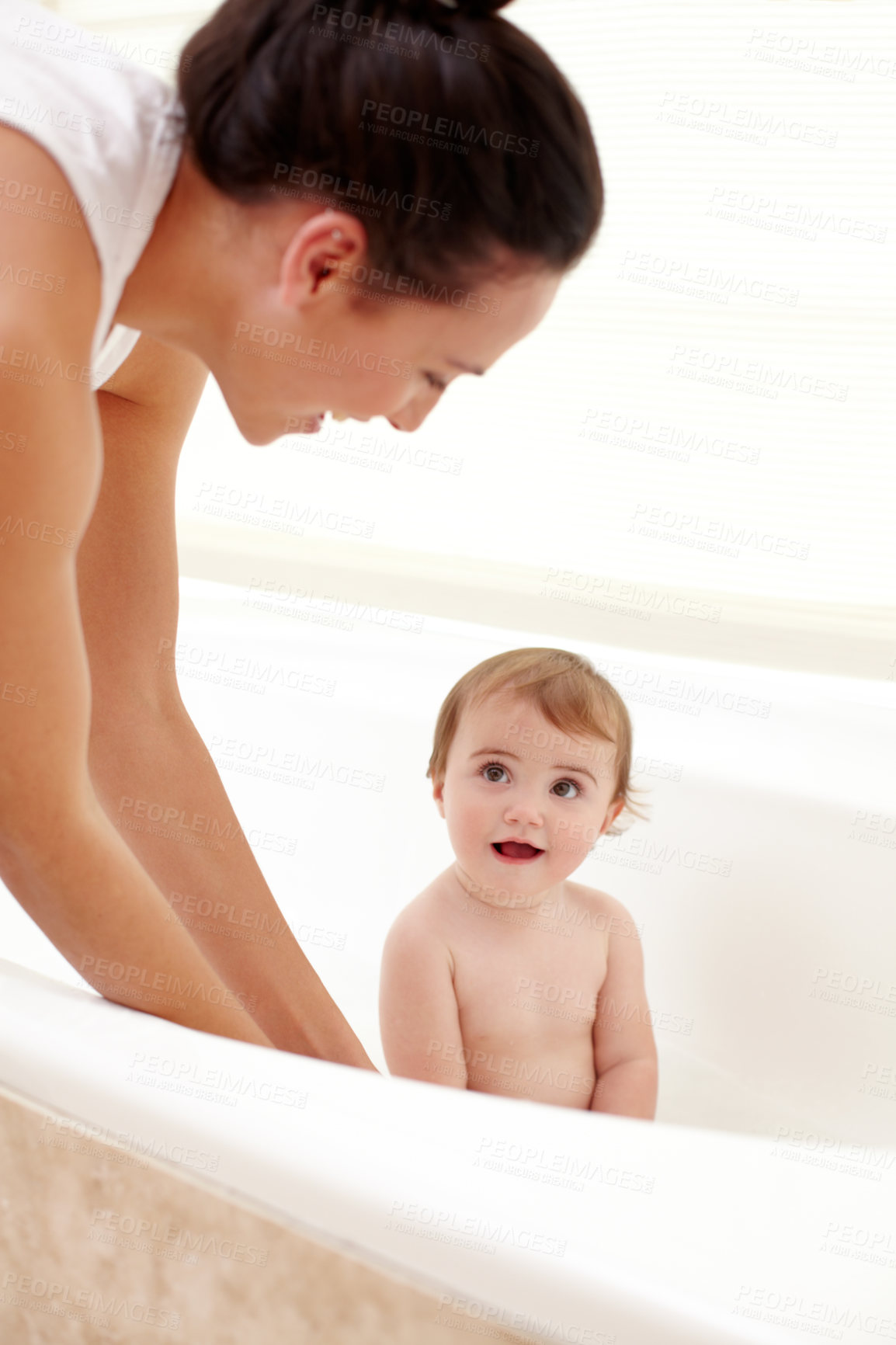 Buy stock photo Baby in bathtub with mom, water and clean fun in home for skincare, wellness and hygiene. Bubble bath, soap and happy child in bathroom with cute face, care and washing body of dirt, germs and mother