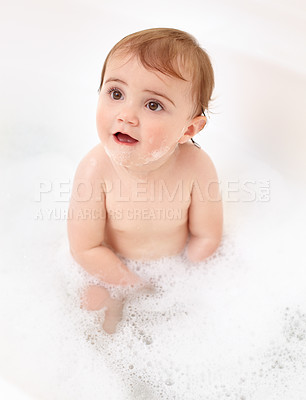Buy stock photo Baby in bathtub with foam, water and clean fun in home for skincare, wellness and hygiene. Bubble bath, soap and happy child in bathroom with cute face, care and washing body of dirt, germs and smile