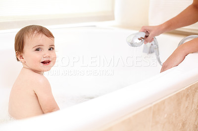 Buy stock photo Portrait of an adorable baby girl in the bath while her mother watches over her