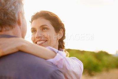 Buy stock photo Mature, couple and smile in embrace at sunset with love, trust and support in marriage or partnership. Happy, woman and care together with freedom, health or wellness at beach for vacation or holiday