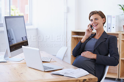 Buy stock photo A pregnant businesswoman having an enjoyable conversation on the phone at her office desk