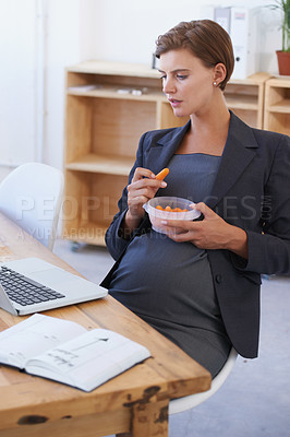 Buy stock photo Business woman, pregnant and eating carrots for healthy diet, nutrition or food at office. Female person or employee in pregnancy or maternity with laptop and natural organic vegetables at workplace