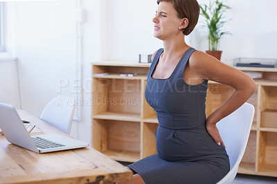 Buy stock photo Business woman, pregnant and back ache in stress, anxiety or mental health with laptop at office. Female person or employee with sore spine or injury in maternity or pregnancy by desk at workplace
