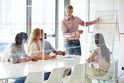 Buy stock photo A group of businesspeople listening to their team leader