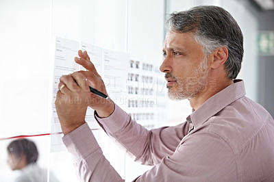 Buy stock photo A mature businessman planning his next move