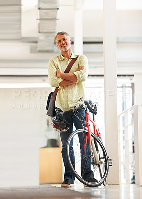 Buy stock photo Full length shot of a handsome bike messenger in an office