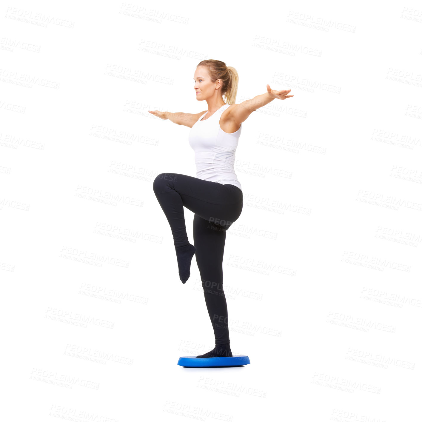 Buy stock photo Full length studio shot of a beautiful young woman doing balance exercises isolated on white