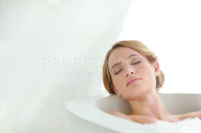 Buy stock photo A beautiful young woman closing her eyes and enjoying a luxurious bath