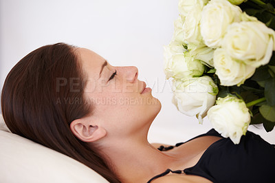 Buy stock photo Flowers, roses and woman sleeping in bedroom for resting, relax and peaceful with eyes closed. Flower bouquet, love and girl smell blossom of valentines day gift, present and romantic gesture in bed
