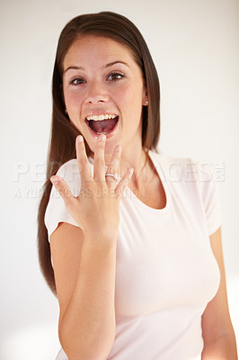 Buy stock photo Portrait of woman excited with ring for engagement, marriage and wedding on white background. Love, wow and happy girl show diamond jewellery on hand for romance celebration, commitment and proposal