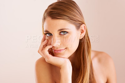 Buy stock photo Studio portrait of an attractive young woman with her hand on her chin smiling at the camera