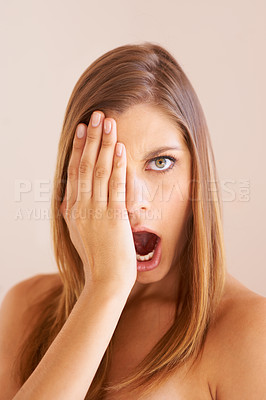 Buy stock photo Cover eye, portrait and surprise with woman, news and gossip on a beige background. Face, person and model with gossip, cosmetics or shock with announcement, facial expression and beauty with makeup 