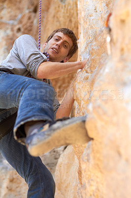 Buy stock photo Portrait of a young rock climber on a climbing rockface