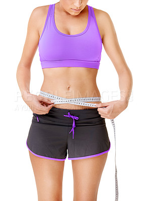Buy stock photo Woman, measuring tape or stomach for weight loss in studio with fitness, wellness or body progress. Person, belly or waist with target for exercise, training or workout on white background and face