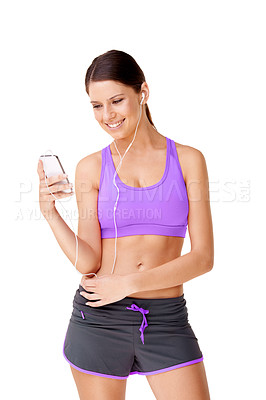 Buy stock photo Shot of a sporty young women listing to music on an mp3 player isolated on white