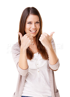 Buy stock photo Studio shot of positive young woman showing thumb's up against a white background