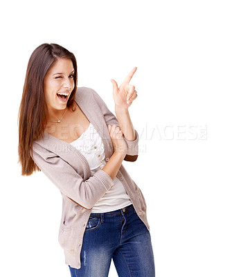 Buy stock photo Studio shot of a young woman pointing up and laughing against a white background