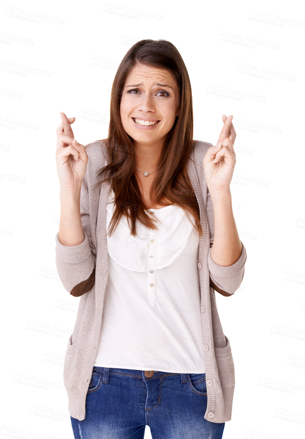 Buy stock photo Casually dressed young woman with her fingers crossed against a white background