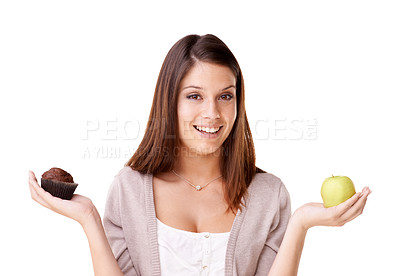 Buy stock photo Portrait of a beautiful young woman deciding between an apple and a muffin