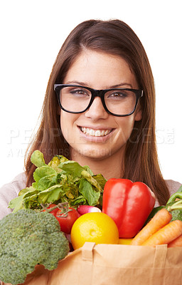 Buy stock photo Portrait of an attractive young woman holding a bag of groceries