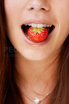 Buy stock photo Cropped image of a woman with a strawberry in her mouth