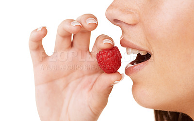Buy stock photo Cropped profile of a woman about to eat a raspberry