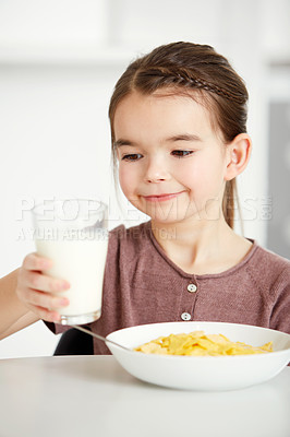 Buy stock photo Happy girl, milk and cereal for breakfast morning, calcium or natural nutrition in kitchen at home. Young female person, child or kid with glass of cream for food, meal or snack in health or wellness