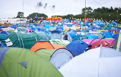 Buy stock photo Shot of a campsite filled with many colorful tents at an outdoor festival