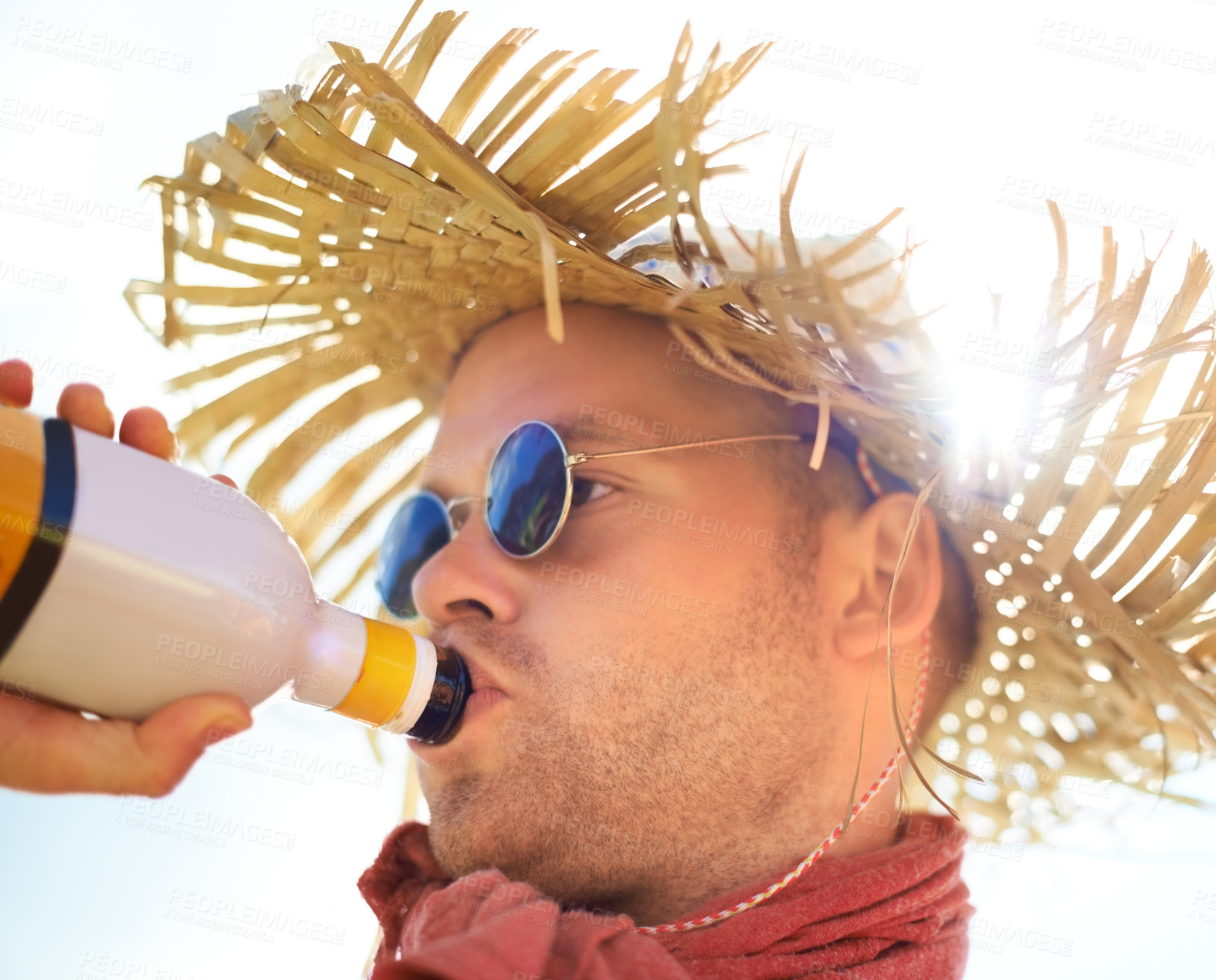 Buy stock photo Man, drinking and alcohol with sunlight outdoor for concert, event or music festival with sunglasses and straw hat. Person, drink and beverage in summer for relax, freedom and enjoyment with sunshine