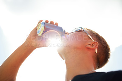 Buy stock photo Closeup of a young man wearing sunglasses drinking a beer outside